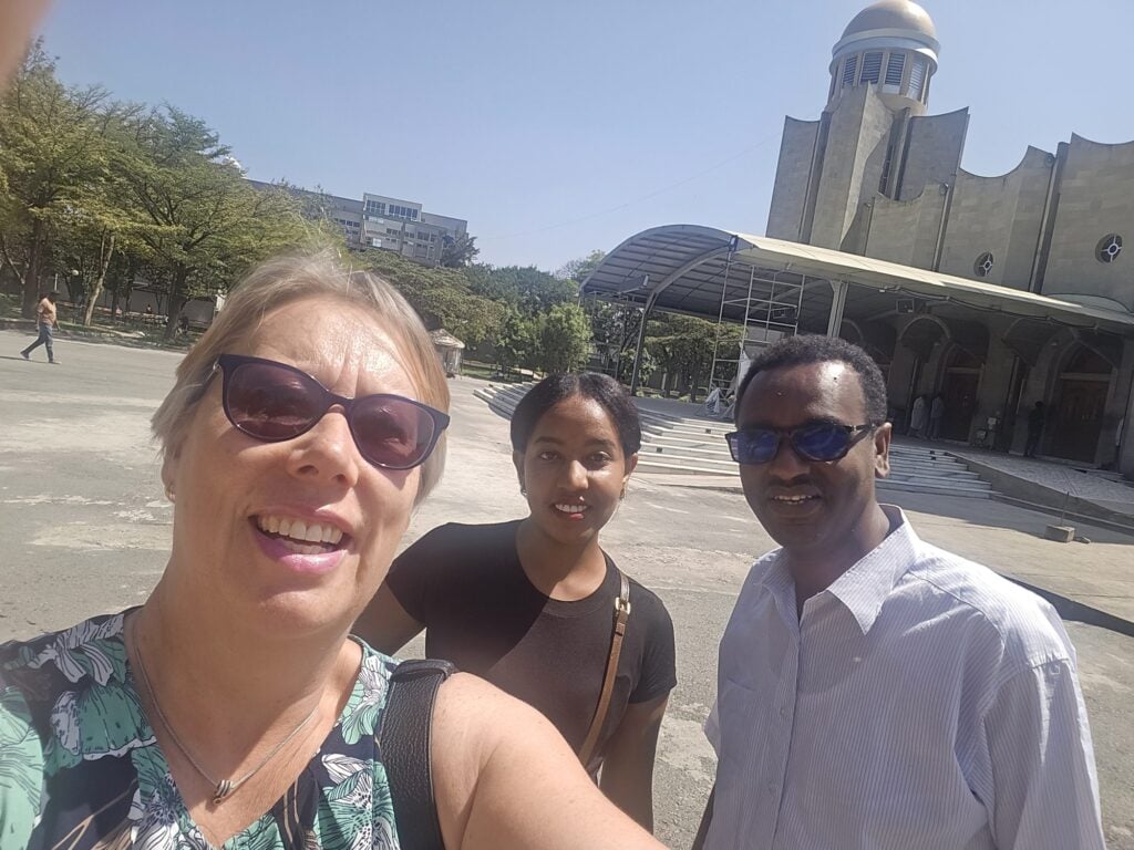 Marie-Louise Norozi with coordinator Samri Milkias and a colleague in front of a large domed church