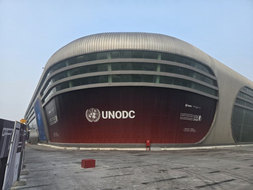 The ADNEC centre in Abu Dhabi with a large UNODC banner across its curved facade for the 15th UN Crime Congress