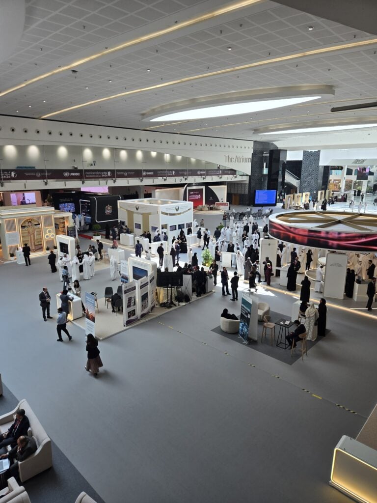 Delegates among the exhibition stands in the atrium at ADNEC Abu Dhabi before the 15th UN Crime Congress