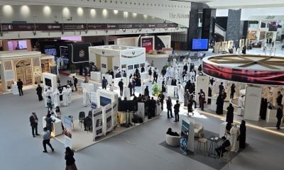 Delegates among the exhibition stands in the atrium at ADNEC Abu Dhabi before the 15th UN Crime Congress